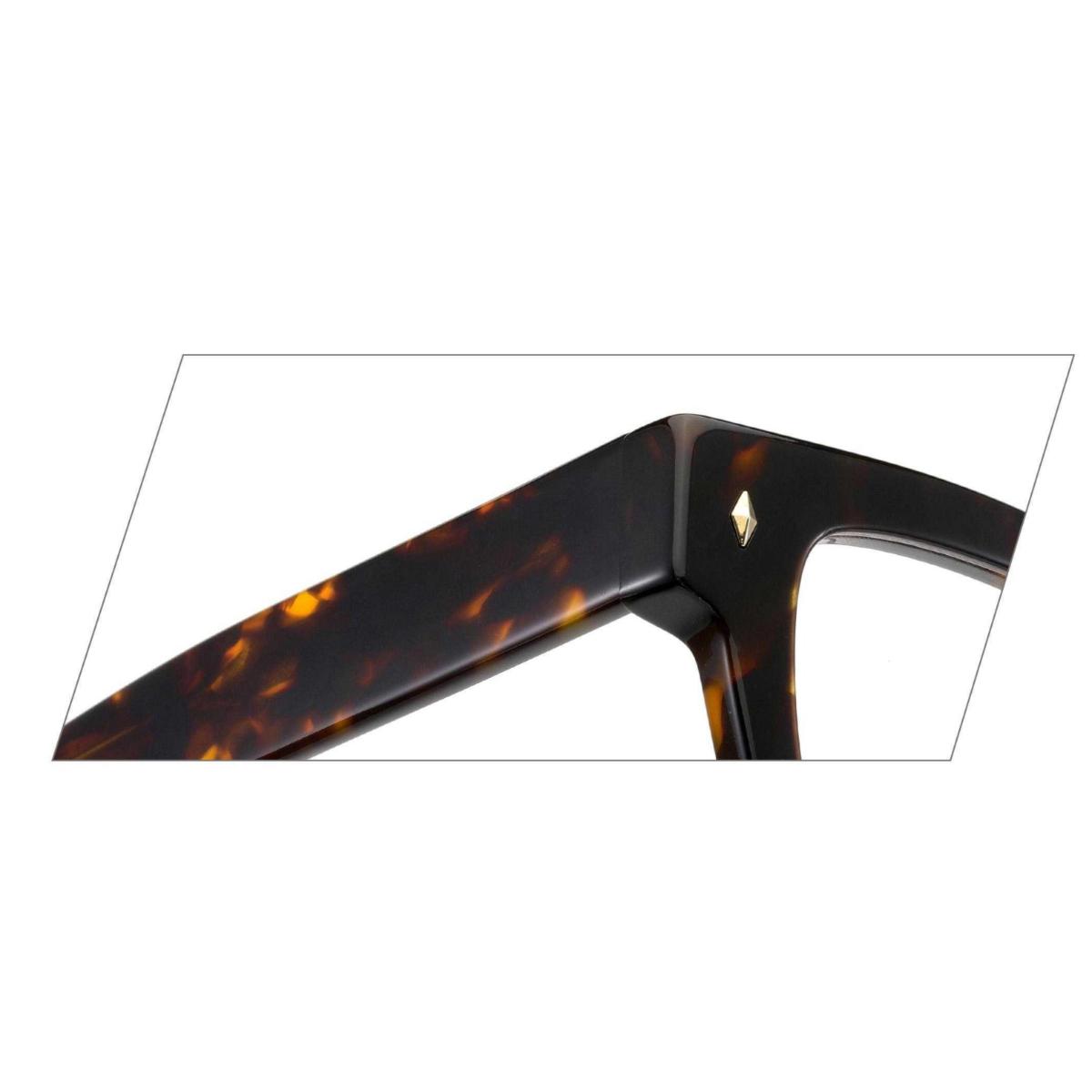 Close-up of ARTISAN Axis dual-tone acetate rectangular eyeglasses showing reinforced hinge design and layered acetate construction