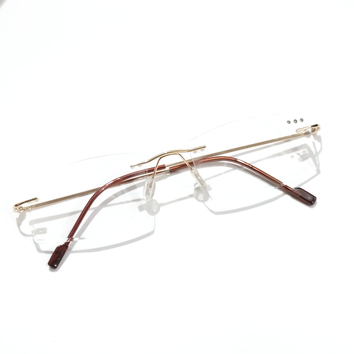 Gold Rimless Executive Glasses with Laser Cut Edges and Left Lens Design