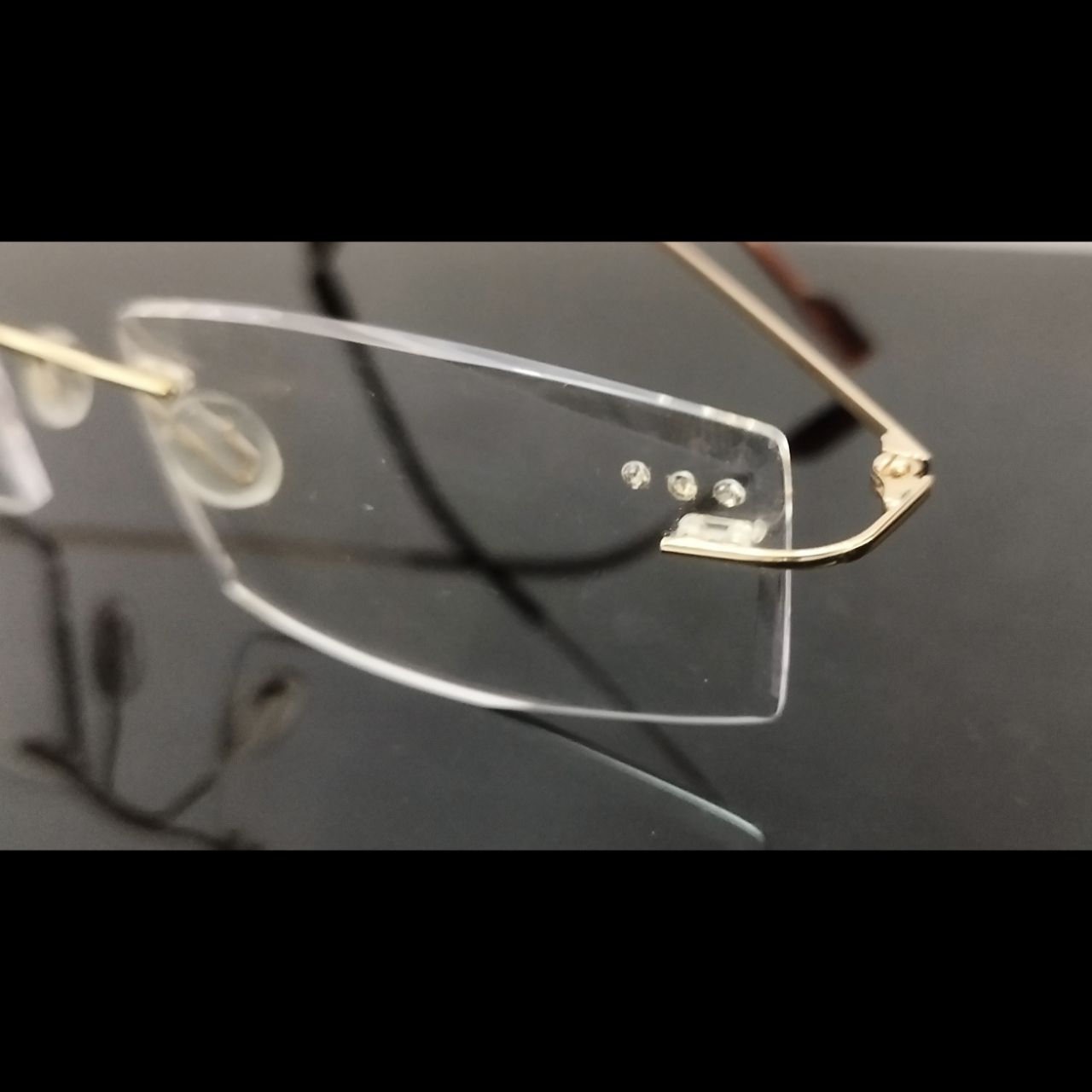 Gold Rimless Executive Glasses with Laser Cut Edges and Left Lens Design