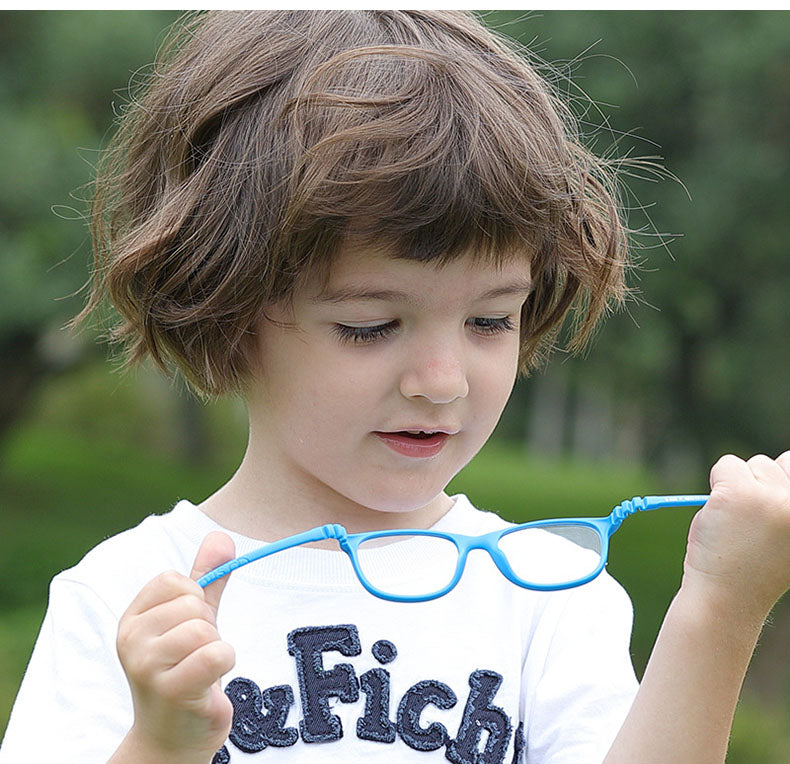 Child holding S303 flexible kids glasses to demonstrate frame flexibility